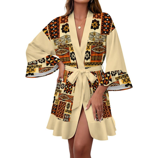 A woman wearing a cream-colored kimono-style robe with a bold African tribal geometric pattern in brown, black, and orange. The robe features wide bell sleeves, a matching waist tie belt, and a V-neckline, shown against a plain white background.