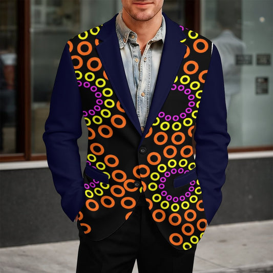 A man wearing a custom printed blazer vest with a navy blue base, black center panel, and a colorful pattern of orange, yellow, and purple concentric rings, styled over a light blue denim shirt.