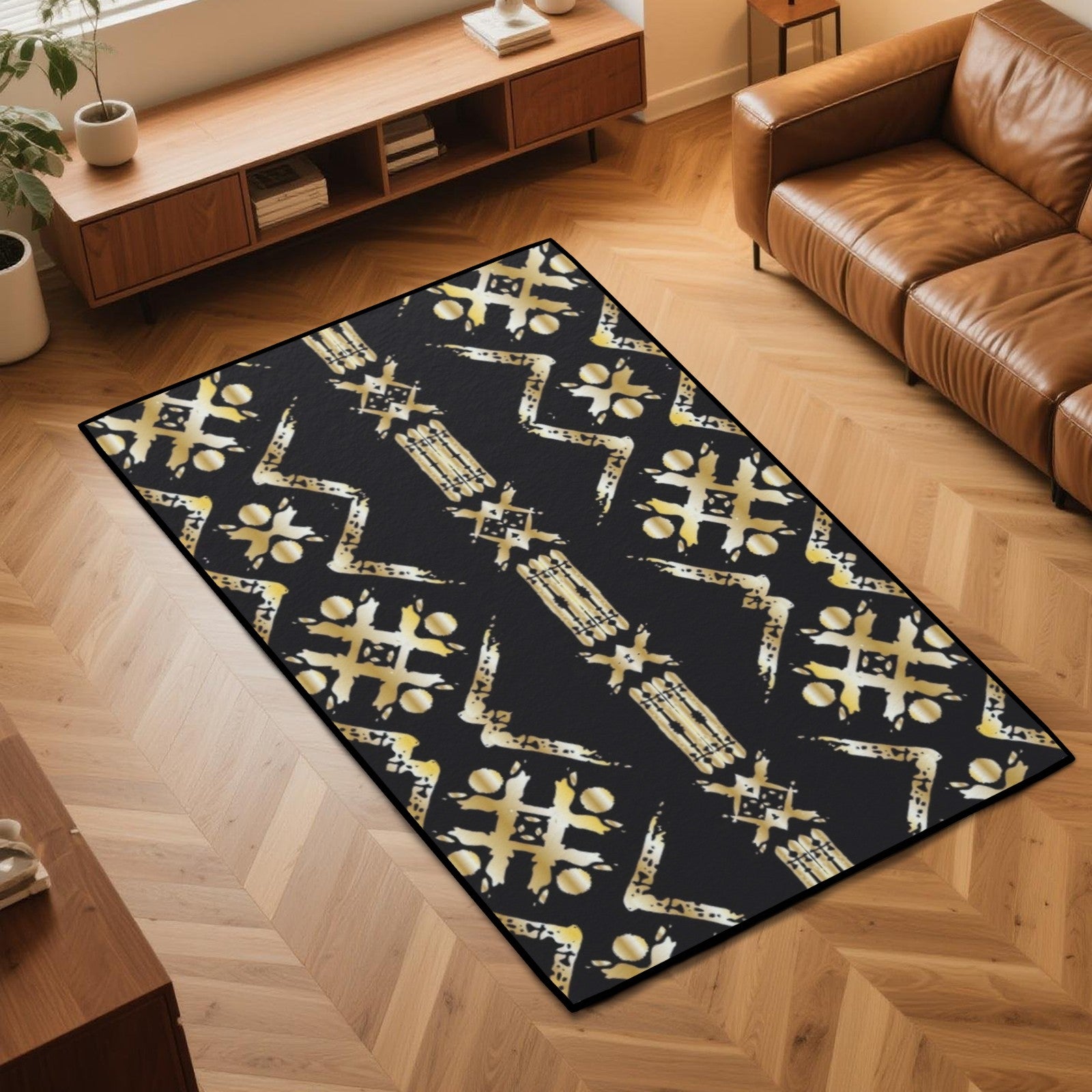 A rectangular area rug with a black background and distressed gold geometric patterns, shown in a modern living room setting on a light wood herringbone floor.