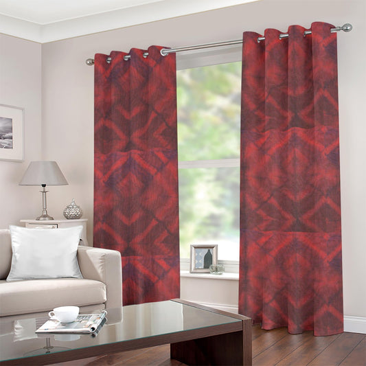 A pair of red and dark gray patterned grommet curtains hanging on a silver rod in a living room setting.
