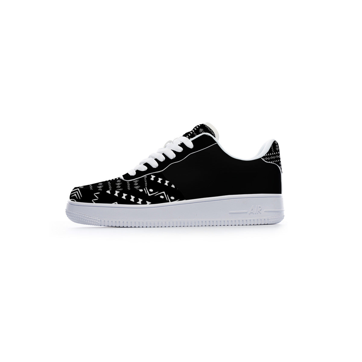 A black low-top sneaker with white laces, a white midsole, and white geometric tribal-style patterns printed on the toe box and heel.