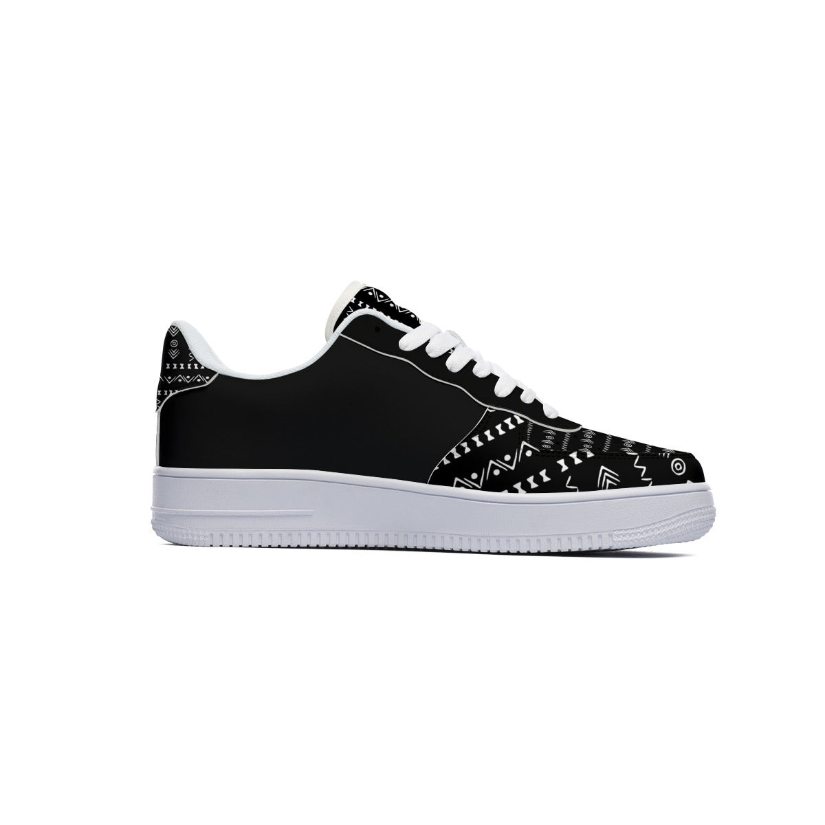 A black low-top sneaker with white geometric tribal patterns on the toe box and heel, white laces, and a thick white rubber sole, shown in a side profile on a white background.