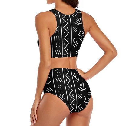 A woman modeling a black two-piece swimsuit with a white geometric pattern, shown from the back against a plain white background.